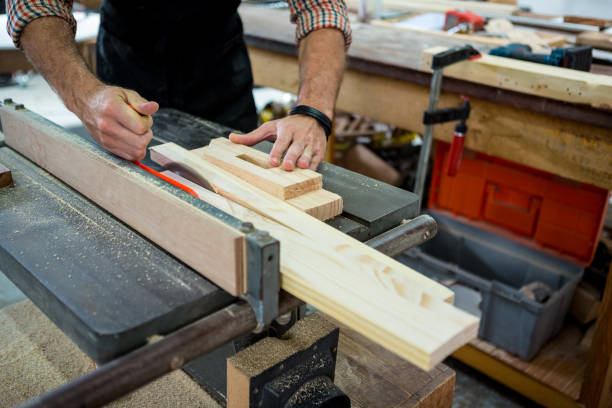 Man refining and shaping plywood for finishing