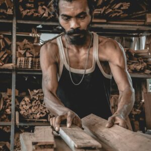 Worker handling plywood to maintain quality standards