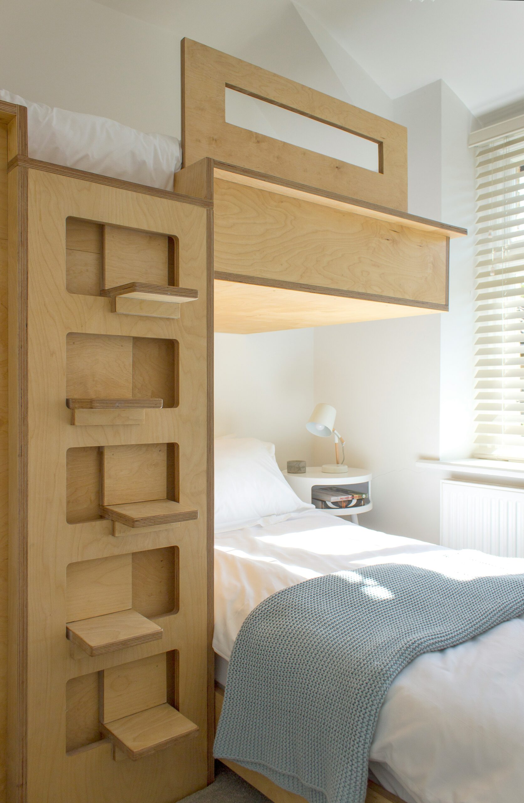 Durable plywood bunk bed design featuring integrated steps for modern home interiors.