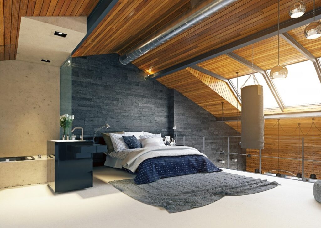 Stylish attic bedroom featuring wooden ceiling, grey accent wall, and natural light.